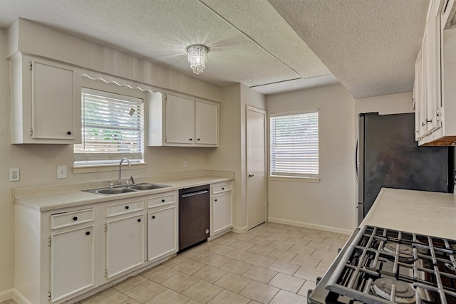 29318 Waltham St, Spring, TX 77386 - kitchen with appliances with stainless steel finishes, white cabinets, a textured ceiling, light countertops, and light tile patterned floors