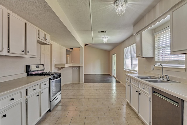 29318 Waltham St, Spring, TX 77386 - kitchen featuring stainless steel appliances, white cabinets, light countertops, and a textured ceiling