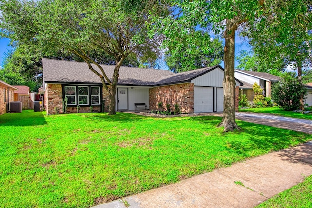 13403 Splintered Oak Dr, Houston, TX 77065 - view of front of property with a garage, driveway, a front lawn, and brick siding