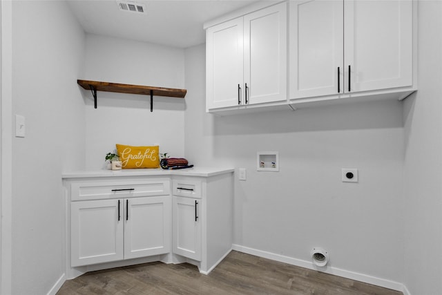 13403 Splintered Oak Dr, Houston, TX 77065 - laundry area with electric dryer hookup, washer hookup, wood finished floors, and cabinet space