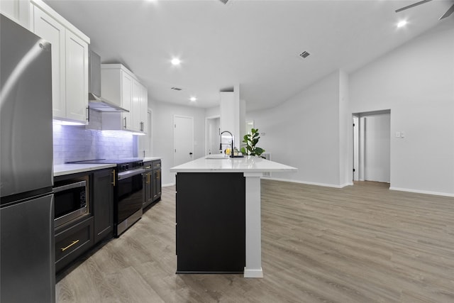 13403 Splintered Oak Dr, Houston, TX 77065 - kitchen with stainless steel appliances, wall chimney range hood, light countertops, decorative backsplash, and white cabinetry