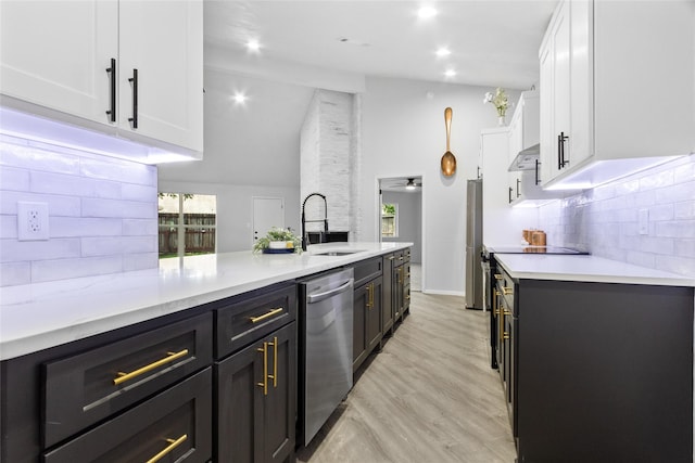 13403 Splintered Oak Dr, Houston, TX 77065 - kitchen featuring appliances with stainless steel finishes, white cabinetry, tasteful backsplash, high vaulted ceiling, and dark cabinetry