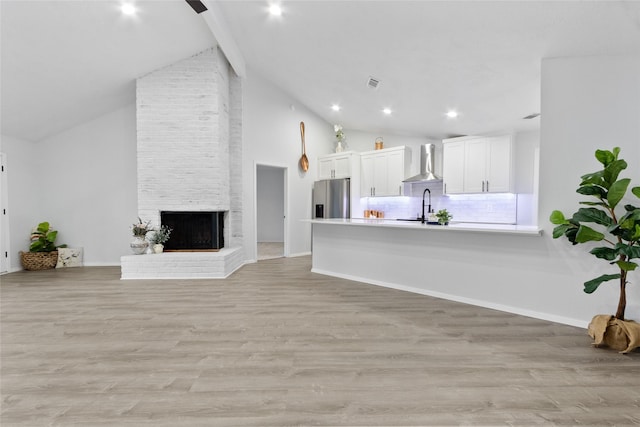 13403 Splintered Oak Dr, Houston, TX 77065 - living room featuring light wood-type flooring, a fireplace, high vaulted ceiling, and recessed lighting