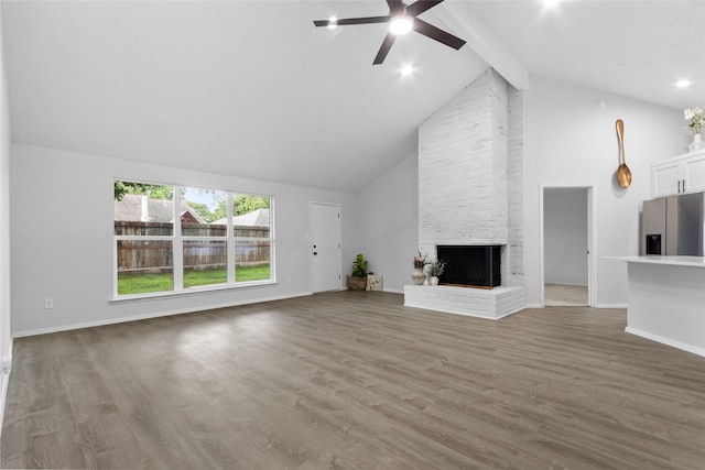 13403 Splintered Oak Dr, Houston, TX 77065 - unfurnished living room featuring beamed ceiling, a ceiling fan, a brick fireplace, high vaulted ceiling, and wood finished floors