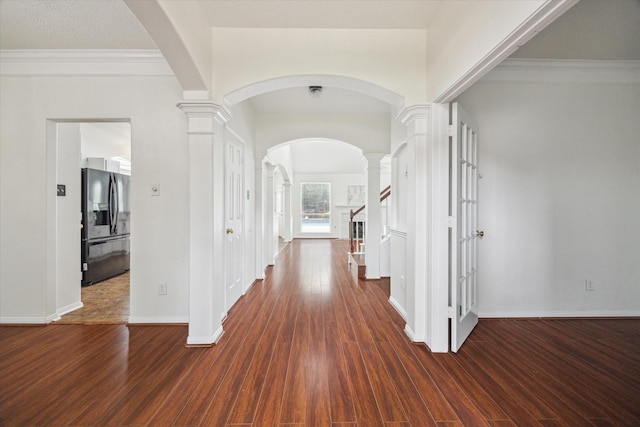 18518 Autumn Park Dr, Houston, TX 77084 - foyer with decorative columns, dark wood finished floors, arched walkways, and crown molding