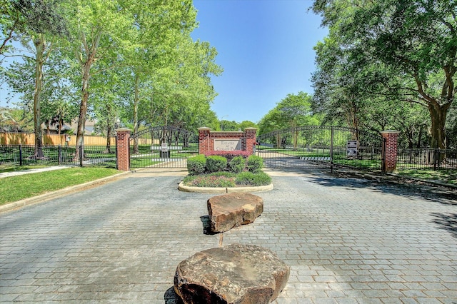 18518 Autumn Park Dr, Houston, TX 77084 - view of street featuring a gate, curbs, a gated entry, and sidewalks