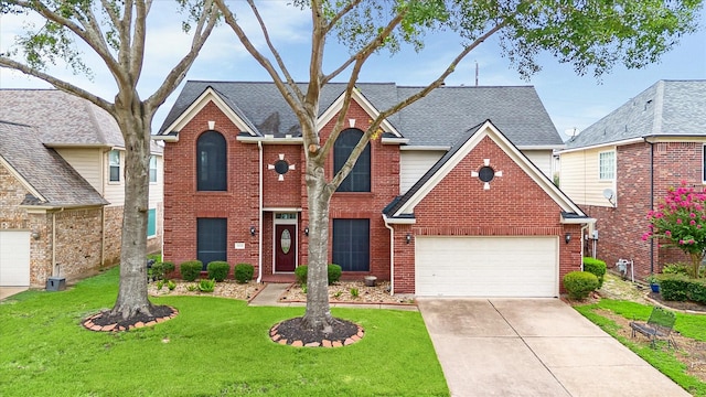 18518 Autumn Park Dr, Houston, TX 77084 - traditional home featuring brick siding, a front lawn, driveway, and a shingled roof