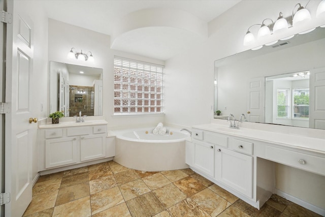 18518 Autumn Park Dr, Houston, TX 77084 - full bath with a stall shower, stone tile flooring, two vanities, and a bath