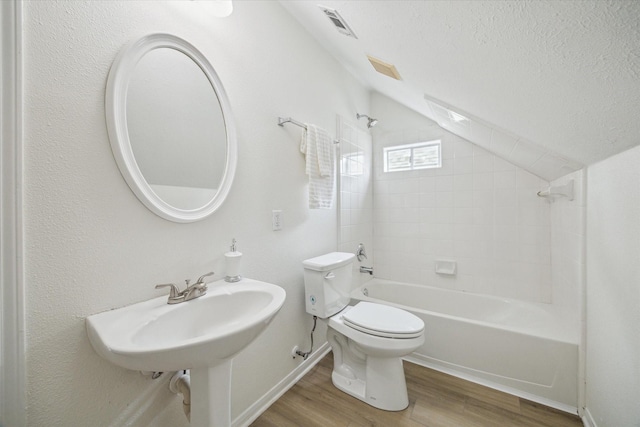 18518 Autumn Park Dr, Houston, TX 77084 - full bath with wood finished floors, lofted ceiling, shower / bathtub combination, and a textured ceiling