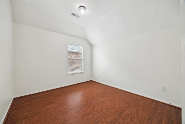 18518 Autumn Park Dr, Houston, TX 77084 - additional living space with dark wood-style floors, lofted ceiling, and a textured ceiling