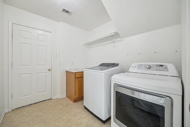 18518 Autumn Park Dr, Houston, TX 77084 - laundry room with washing machine and dryer, light flooring, and a textured ceiling