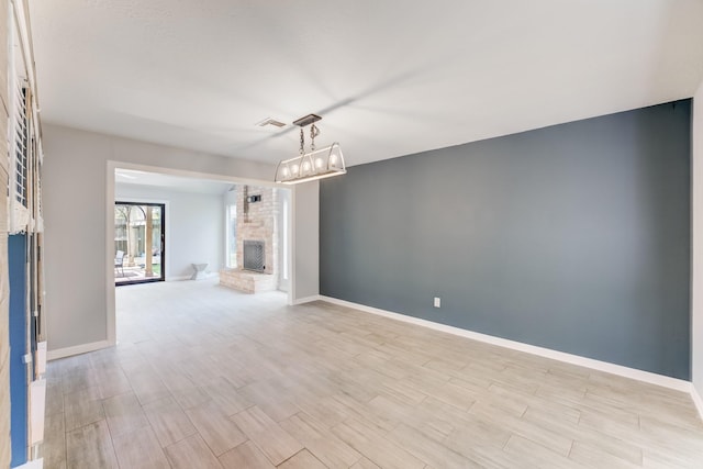 15615 Oldridge Dr, Houston, TX 77084 - unfurnished living room featuring light wood-type flooring and a brick fireplace