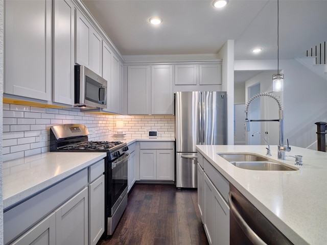 400 Beken Cove Ln, La Porte, TX 77571 - kitchen featuring appliances with stainless steel finishes, dark wood finished floors, decorative light fixtures, tasteful backsplash, and recessed lighting