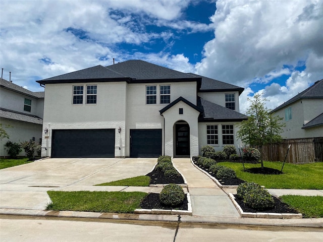 10011 Serenity Grove Dr, Missouri City, TX 77459 - view of front of house with a garage, driveway, and stucco siding