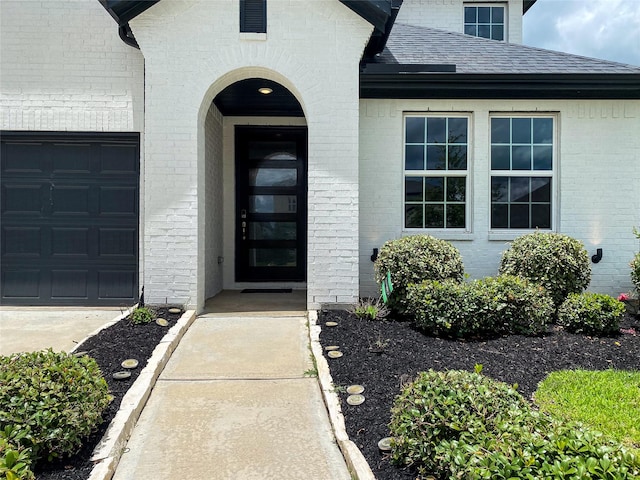 10011 Serenity Grove Dr, Missouri City, TX 77459 - property entrance with a shingled roof and brick siding