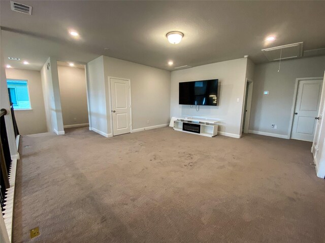 10011 Serenity Grove Dr, Missouri City, TX 77459 - unfurnished living room featuring attic access, carpet, and recessed lighting