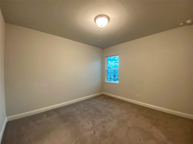 10011 Serenity Grove Dr, Missouri City, TX 77459 - empty room featuring baseboards and dark carpet