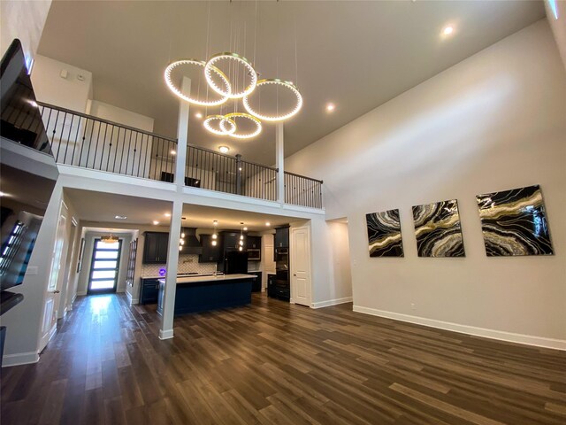 10011 Serenity Grove Dr, Missouri City, TX 77459 - unfurnished living room featuring a high ceiling, dark wood finished floors, and recessed lighting