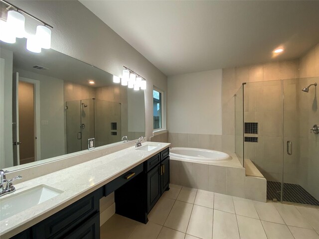 10011 Serenity Grove Dr, Missouri City, TX 77459 - bathroom with a stall shower, a bath, double vanity, tile patterned floors, and recessed lighting