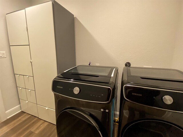 10011 Serenity Grove Dr, Missouri City, TX 77459 - laundry room featuring washer and clothes dryer and wood finished floors