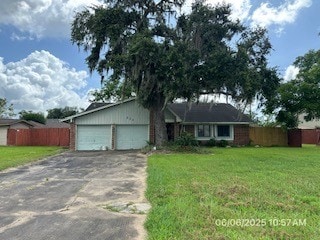 288 Twin Lakes Blvd W, West Columbia, TX 77486 - ranch-style house featuring a garage and driveway