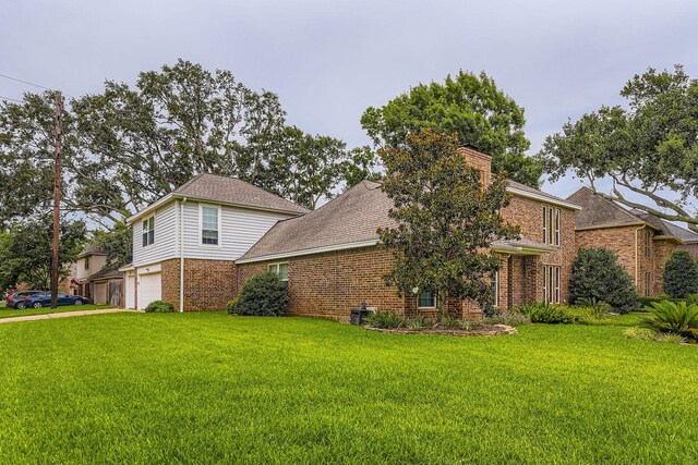 20746 Prince Creek Dr, Katy, TX 77450 - view of home's exterior featuring brick siding, a garage, a yard, and a chimney