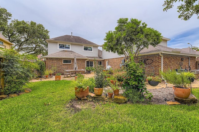 20746 Prince Creek Dr, Katy, TX 77450 - rear view of house with brick siding, a yard, and a patio area