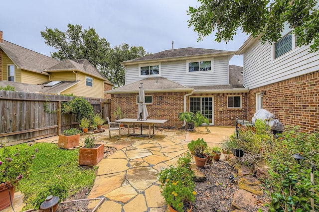 20746 Prince Creek Dr, Katy, TX 77450 - rear view of house featuring brick siding, a patio area, and roof with shingles