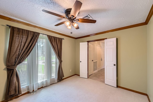 20746 Prince Creek Dr, Katy, TX 77450 - unfurnished bedroom featuring light colored carpet, a textured ceiling, a ceiling fan, and ornamental molding