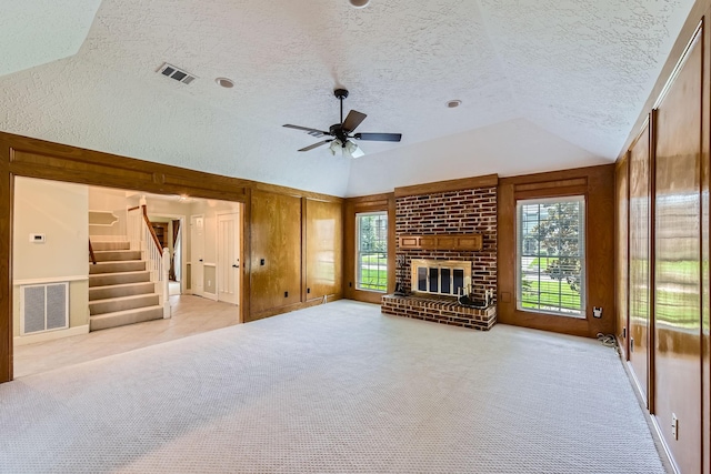 20746 Prince Creek Dr, Katy, TX 77450 - unfurnished living room with vaulted ceiling, a textured ceiling, ceiling fan, stairway, and plenty of natural light