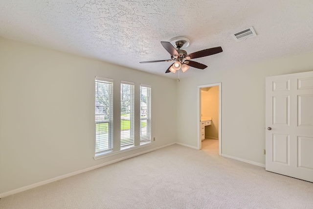 20746 Prince Creek Dr, Katy, TX 77450 - unfurnished bedroom with light carpet, a textured ceiling, ceiling fan, and ensuite bath