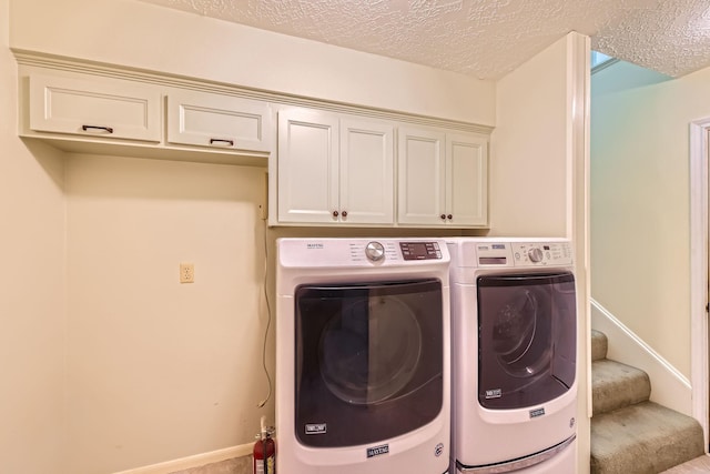 20746 Prince Creek Dr, Katy, TX 77450 - laundry room with washer and dryer, a textured ceiling, and cabinet space