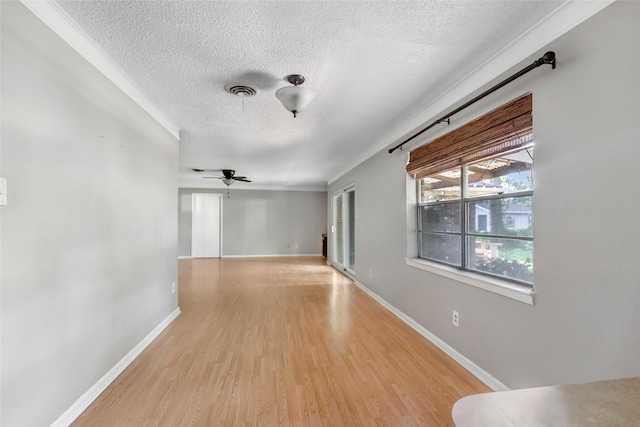 1015 Stevens Ave, Conroe, TX 77301 - spare room with a textured ceiling, light wood-type flooring, ceiling fan, and ornamental molding