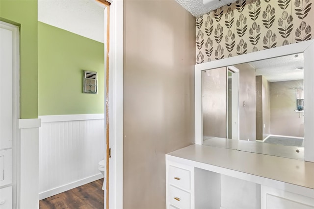 1015 Stevens Ave, Conroe, TX 77301 - bathroom with a textured ceiling, wainscoting, and wood finished floors