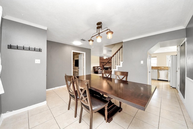 16227 Affirmed Way, Friendswood, TX 77546 - dining room featuring stairs, light tile patterned floors, arched walkways, and crown molding