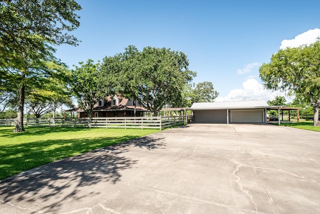4821 Lawrence Rd, Baytown, TX 77523 - view of front facade with a metal roof, an outdoor structure, and driveway