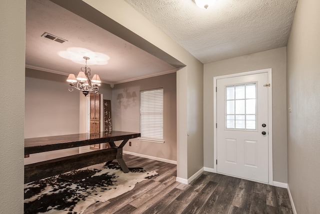 4821 Lawrence Rd, Baytown, TX 77523 - entryway with dark wood-type flooring, a chandelier, a textured ceiling, and crown molding