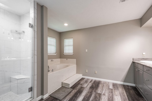 4821 Lawrence Rd, Baytown, TX 77523 - bathroom with vanity, a bath, a stall shower, and wood finished floors