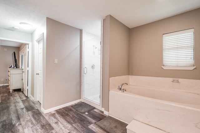 4821 Lawrence Rd, Baytown, TX 77523 - full bath with wood finished floors, a shower stall, and a garden tub