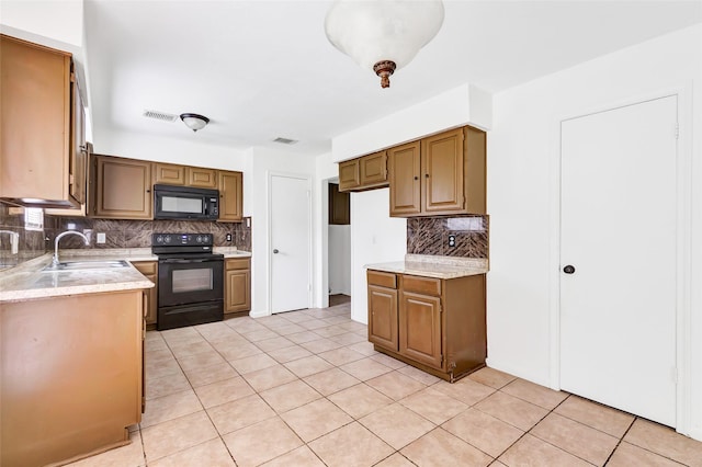 4719 Silver Frost Dr, Houston, TX 77066 - kitchen featuring black appliances, backsplash, and light tile patterned flooring
