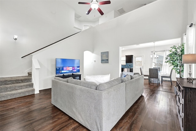 1611 Jaquima Valley Way, Houston, TX 77049 - living room featuring stairs, ceiling fan, dark wood finished floors, a towering ceiling, and a chandelier