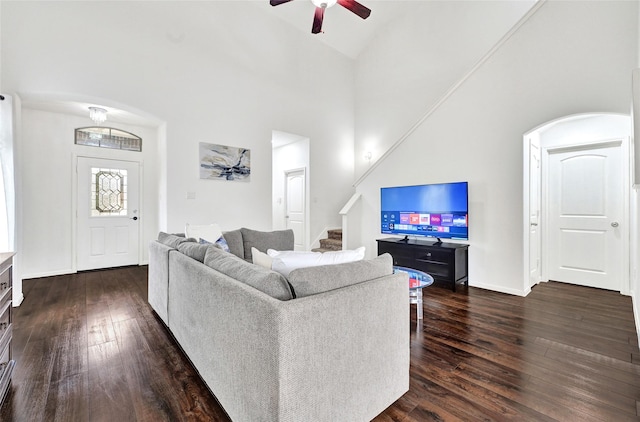 1611 Jaquima Valley Way, Houston, TX 77049 - living area with dark wood-type flooring, stairway, ceiling fan, and high vaulted ceiling