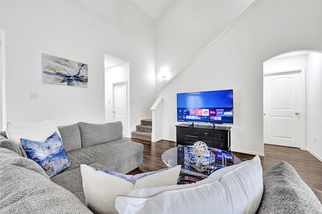1611 Jaquima Valley Way, Houston, TX 77049 - living area featuring wood finished floors, stairway, arched walkways, and high vaulted ceiling
