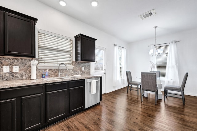 1611 Jaquima Valley Way, Houston, TX 77049 - kitchen featuring stainless steel dishwasher, tasteful backsplash, dark wood-type flooring, a chandelier, and pendant lighting