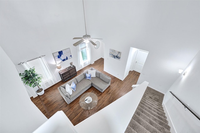 1611 Jaquima Valley Way, Houston, TX 77049 - living room with wood finished floors, a towering ceiling, ceiling fan, and stairs