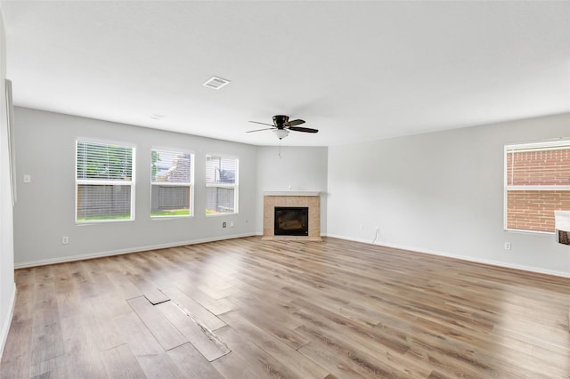 5019 Packard Elm Ct, Katy, TX 77449 - unfurnished living room featuring ceiling fan, light wood finished floors, and a tile fireplace