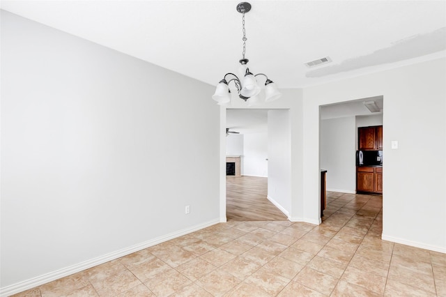 5019 Packard Elm Ct, Katy, TX 77449 - unfurnished room featuring a chandelier and light tile patterned floors