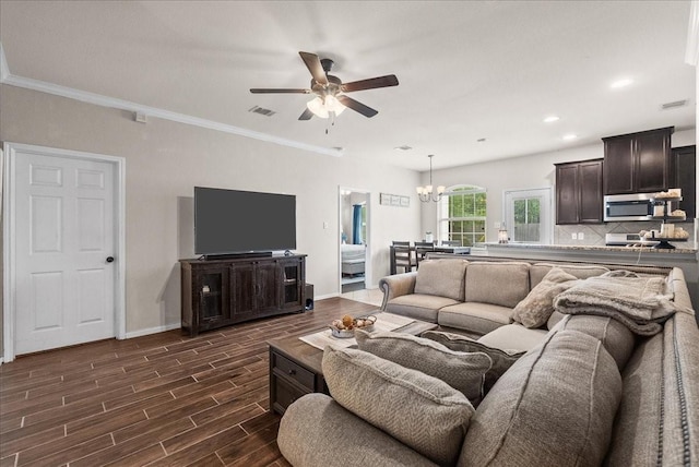 13203 Adolpho Dr, Houston, TX 77044 - living room with a chandelier, a ceiling fan, dark wood-style floors, recessed lighting, and ornamental molding