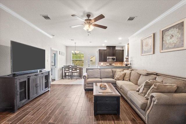 13203 Adolpho Dr, Houston, TX 77044 - living area featuring crown molding, dark wood finished floors, ceiling fan, a chandelier, and recessed lighting