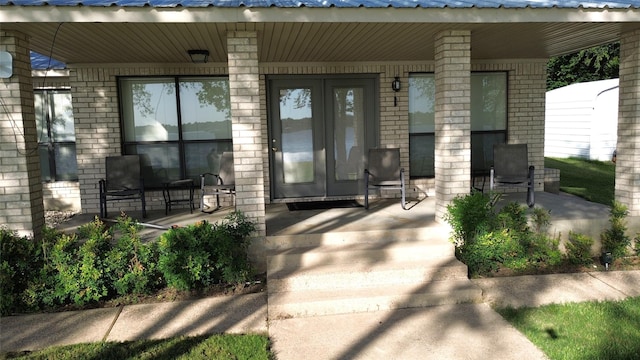 11391 Lakeshore Dr, Thornton, TX 76687 - entrance to property featuring covered porch, brick siding, and a metal roof